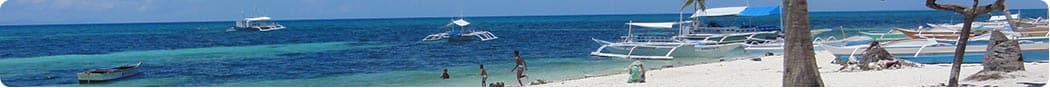 Locals enjoy the beauty of Malapascuas White Beach